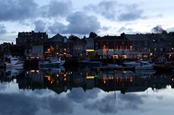 Christmas lights reflecting in Padstows inner harbour