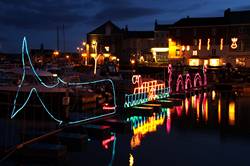 Christmas lights reflecting in Padstows inner harbour