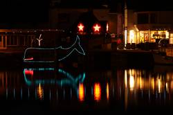 Christmas lights reflecting in Padstows inner harbour